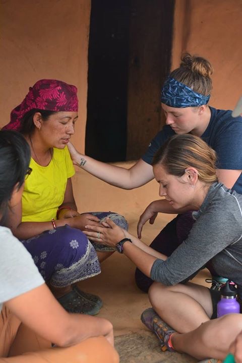 Lacie and her sisters on the field praying with a beautiful Nepali woman as she prays to receive Jesus in her heart for the first time! 